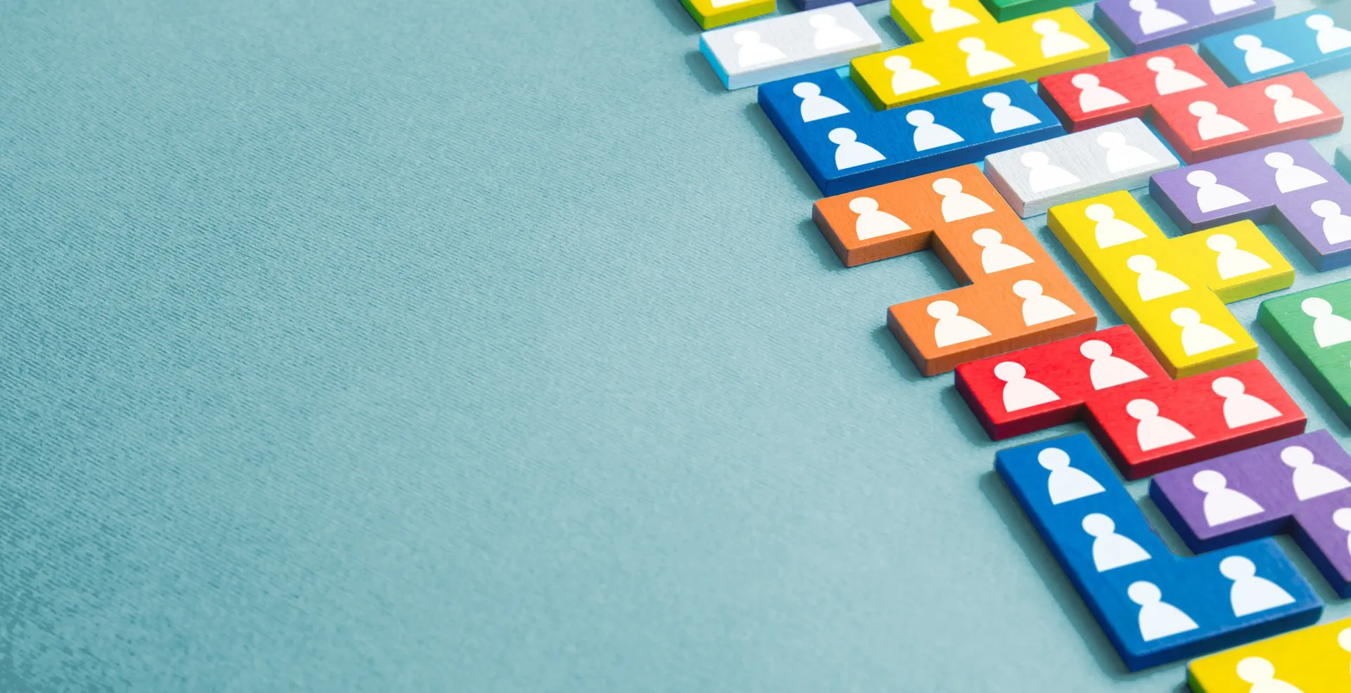 Stock banner image of puzzle pieces with person symbols