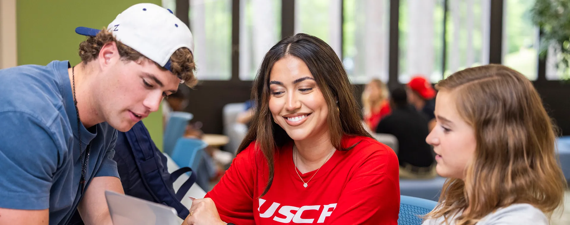 Image of three students collaborating on a project