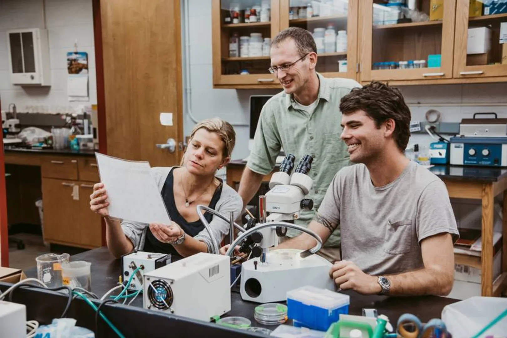 Photo of Nathan Hancock working in the lab with a Megellan Scholar
