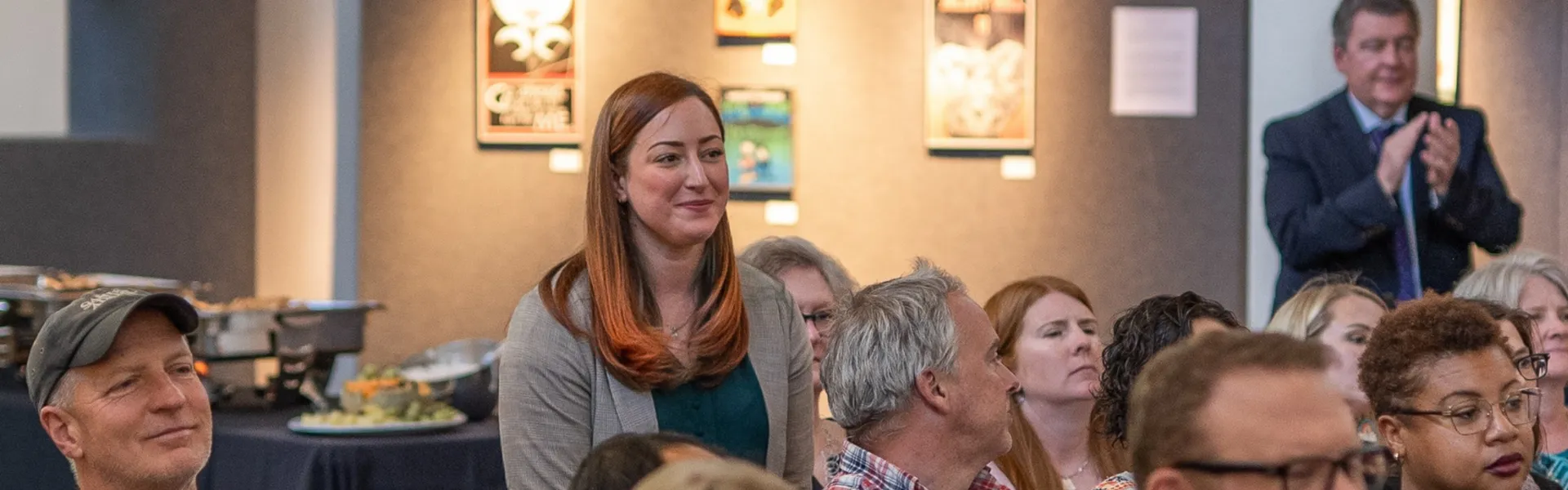 A group of faculty members sitting and watching a presentation.