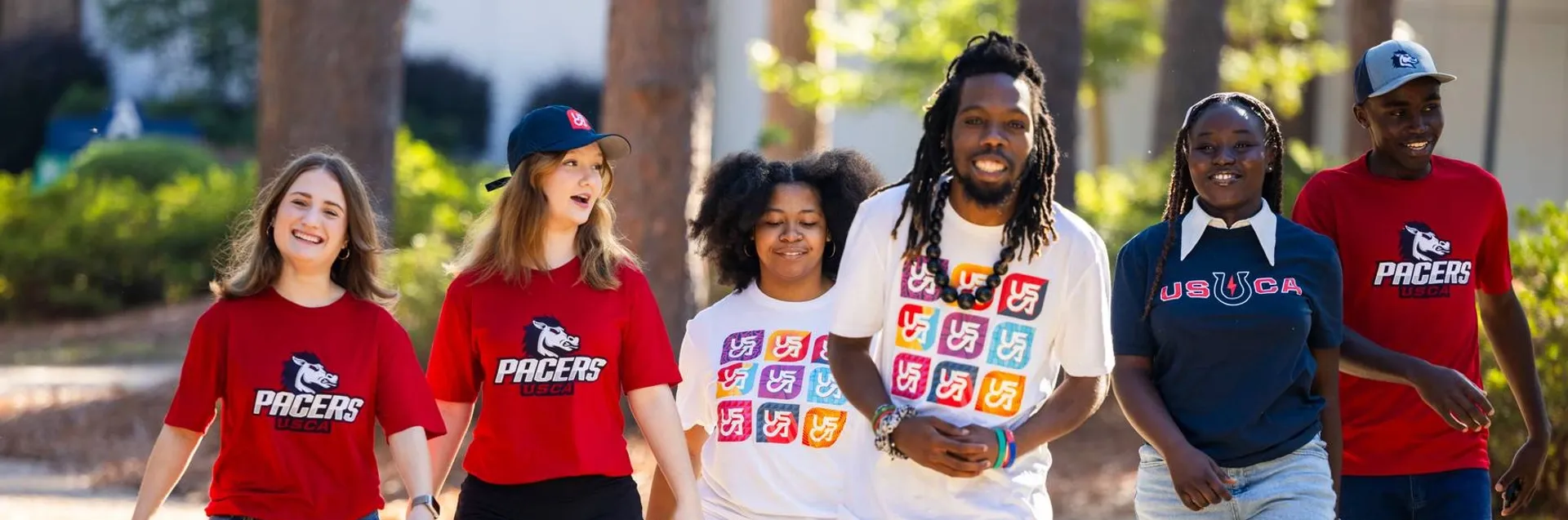 A group of students walking through the USCA quad