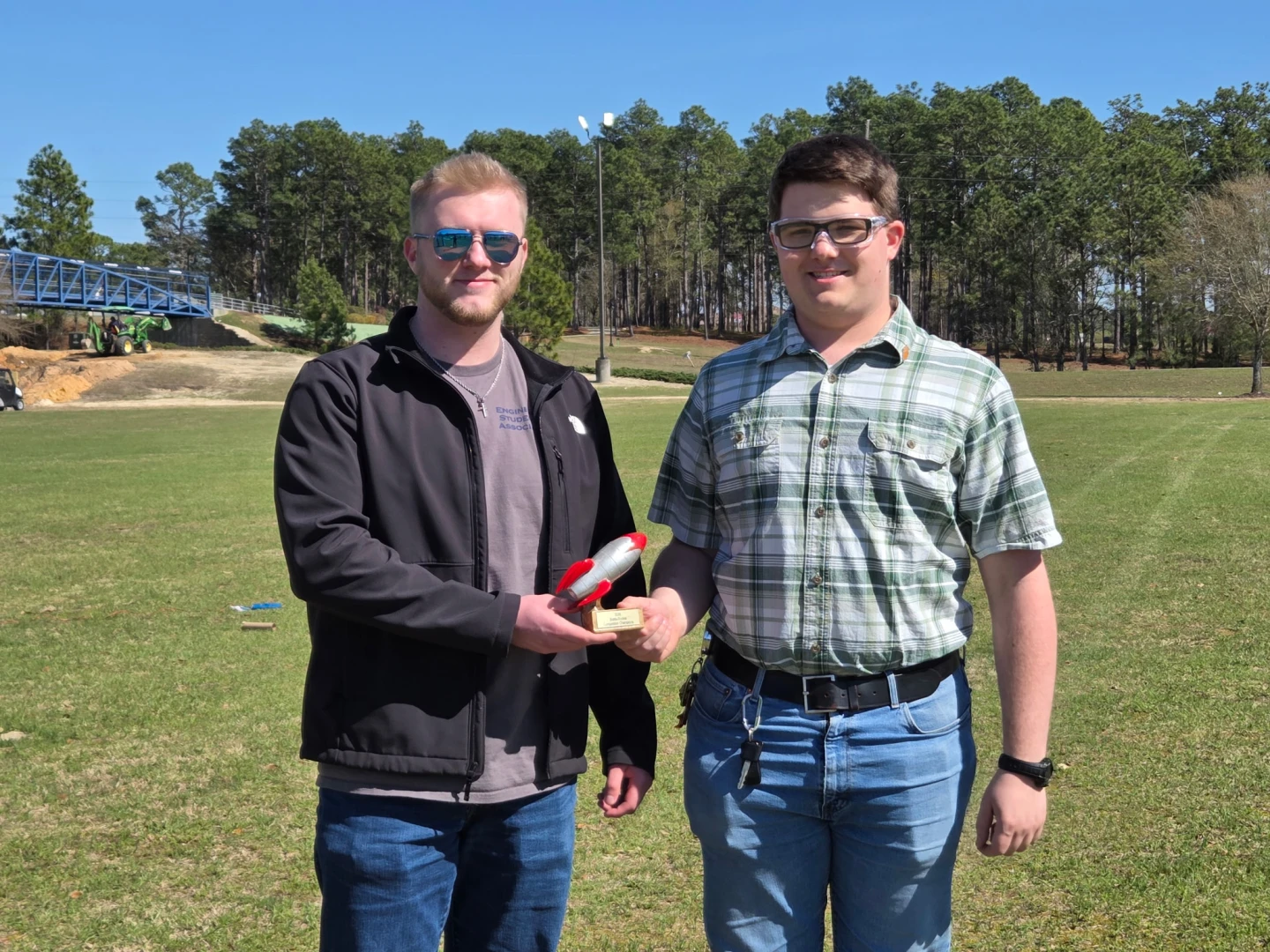 From left, Engineering Student Association President Jake Ormand presents the bottle rocket trophy to Silas Martin, a member of the winning team. (courtesy photo)