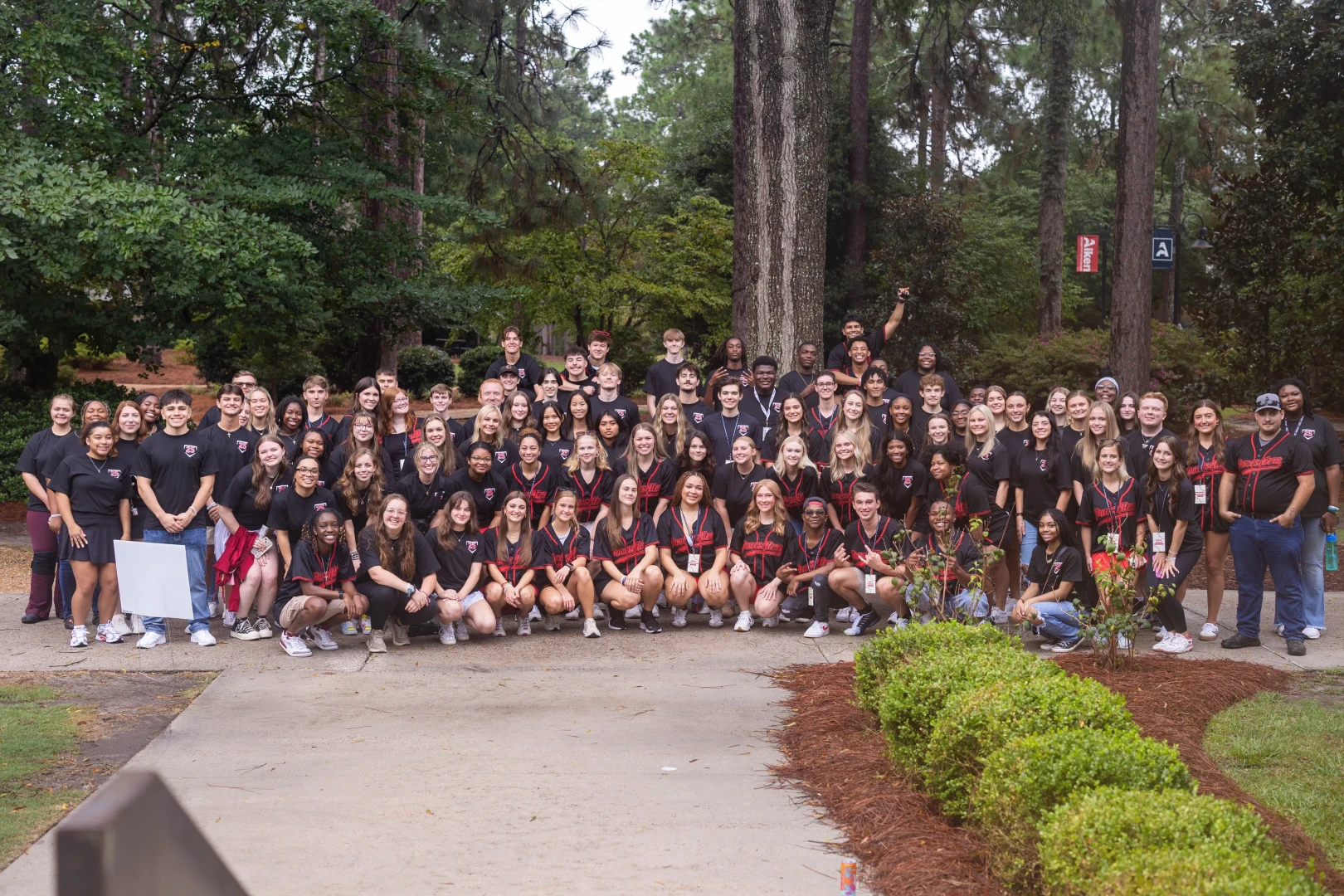 A group of students pose for a photo in the quad.