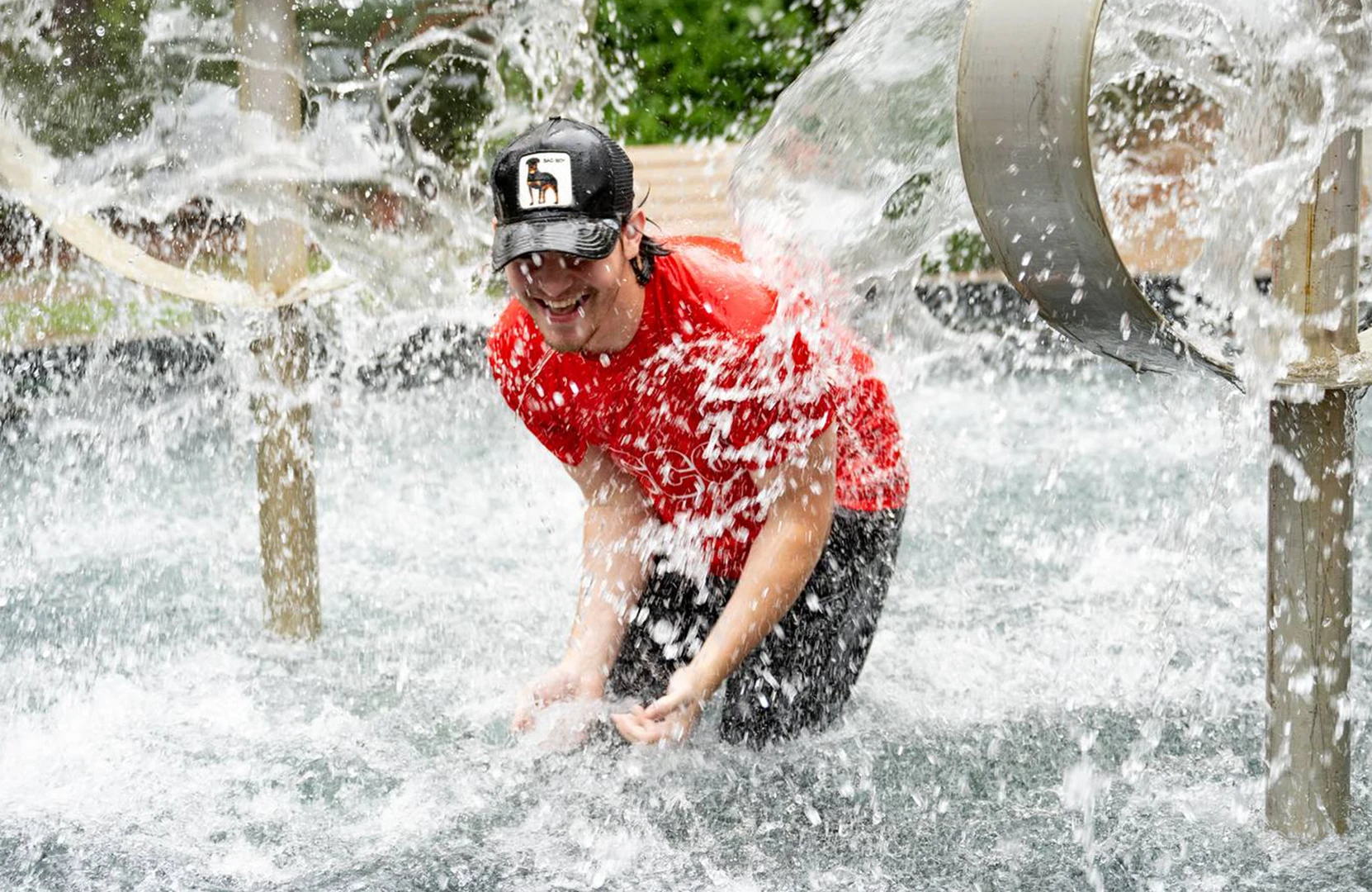 Guy splashes in the fountain