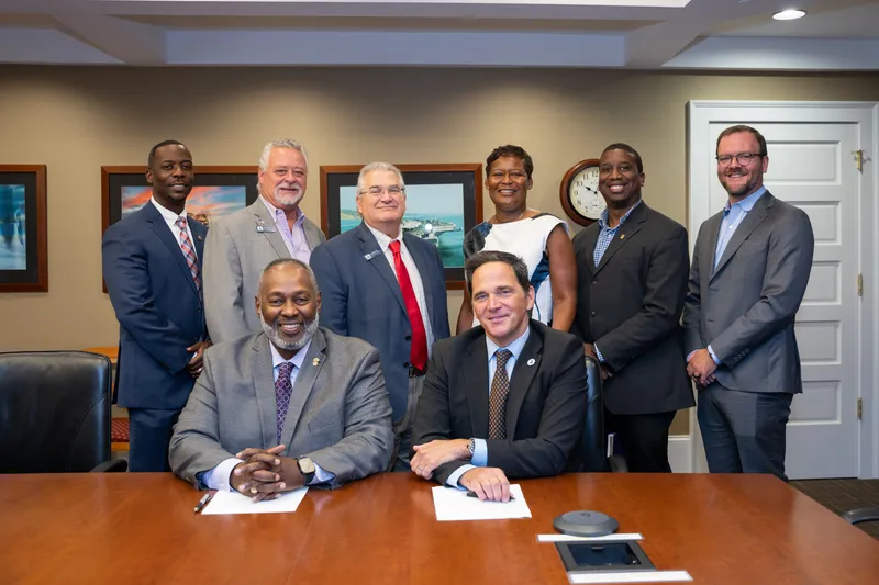 Savannah River Nuclear Solutions Executive Vice President Sean Alford and USCA Chancellor Daniel Heimmermann came together with their teams to sign a memorandum of agreement in the SRNS downtown Aiken office