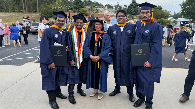 Dr. Hala Strohmier, director of USCA's Center of Cyber Initiative and Awareness, center, celebrated the inaugural cohort of students in the Master of Computer and Information Sciences who graduated May 6.
